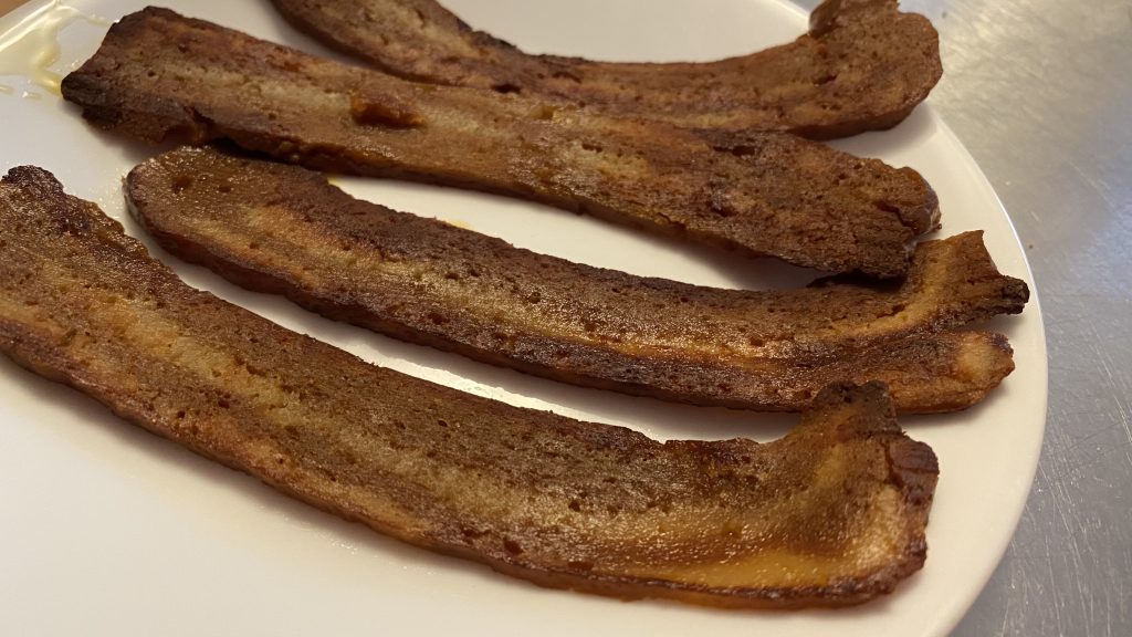 seitan bacon on a white plate